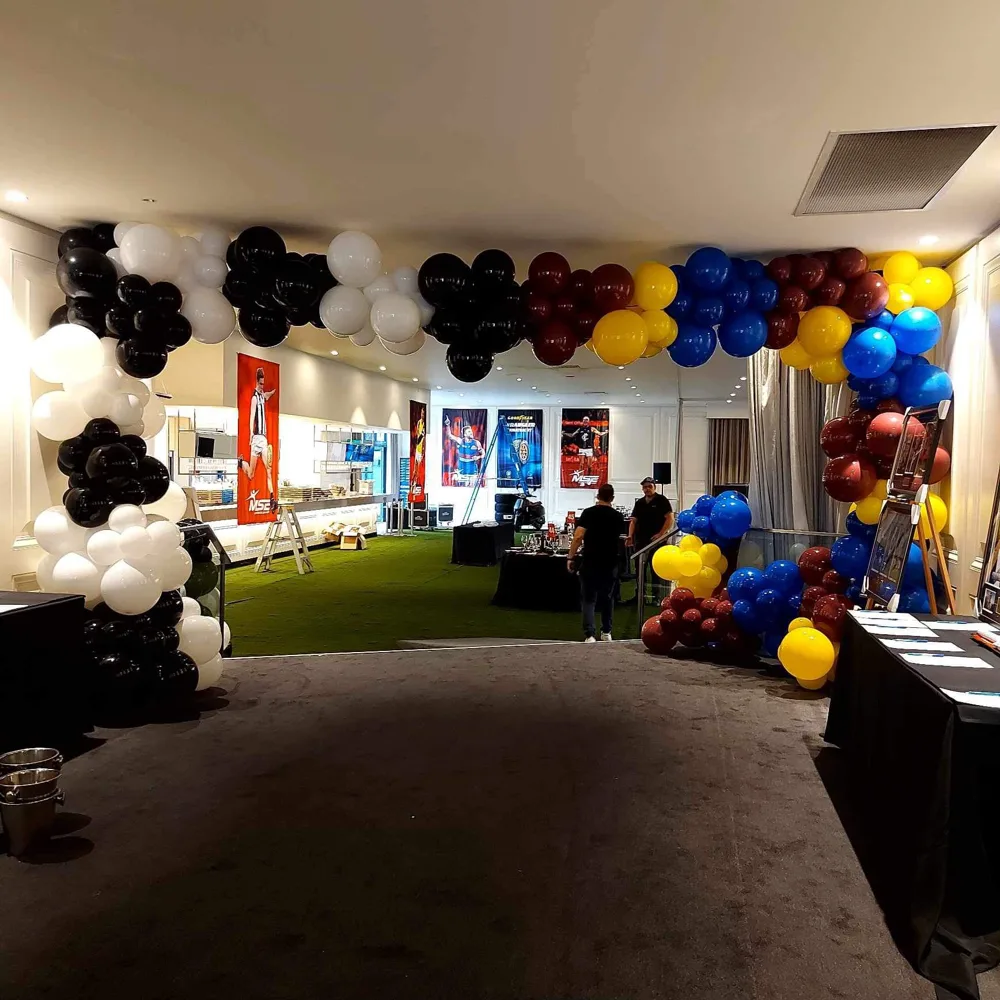 Large multi-colour balloon arch spanning a venue entrance